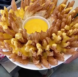 The ONLY thing better than a Bloomin' Onion is a CHEESY BLOOMIN' ONION! 👏👏 (CREDIT: @grubspot on Instagram!) BROWSE TOP SECRET RESTAURANT RECIPES: https://foodtv.com/SecretRecipes | Food Network