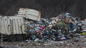 Unloading human waste 4K. Garbage truck unloads city waste. Unsorted trash footage. Pollution of nature with waste. Dump background. Wild birds in the landfill. Environmental pollution. City trash.