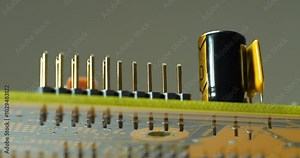 Computer microcircuit with electronic components, resistors and connection terminals. Cinema 4K 60fps zoom-out video