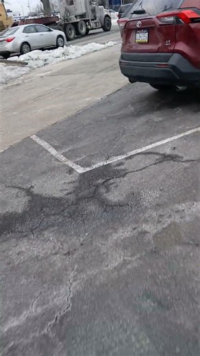 A Peterbuilt flatbed tractor trailer backing up