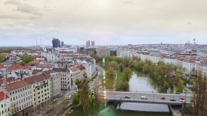 Aerial panoramic view of Austria capital Vienna townscape european urban city architecture flight drone above over Danube river waterway connecting modern old bridge with tourist cars traffic rhythm