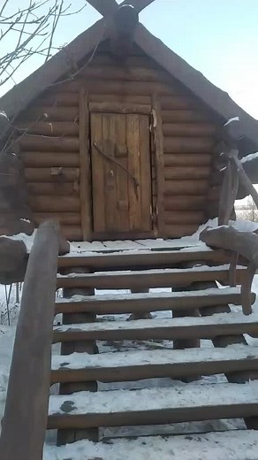 Winter Scene: Woman Exiting a Cozy Log Cabin