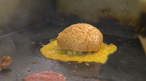 A burger with a skirt of melted cheese in wine country. | The Great Cheese Hunt