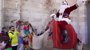 Santa rides a camel around Jerusalem