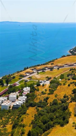 Vertical video. Kilitbahir, Turkey. Mecidiye Bastion overlooking Dardanelles strait with passing ...