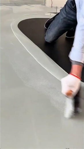 applying self leveling epoxy floor paint using a roller for smooth interior decoration surface