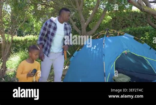 African American father and son arriving for camp in yard, assembling blue tent using orange mallet. Family, parent, child, outdoor, backyard, shelter, setup Stock Video Footage - Alamy