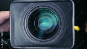 Studio camera. Cameraman changing camera settings focal length, aperture and zoom preparing for shooting. 4K.