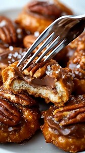 Rolo Pretzel Turtles Ingredients: - 48 Round Pretzels - 48 Rolo's, Unwrapped - 48 Pecan Halves Directions: 1. Preheat the oven to 300 degrees Fahrenheit. 2. Line a baking sheet with parchment paper. 3. Distribute 48 round pretzels evenly on the baking sheet. 4. Unwrap 48 Rolo's and place one in the center of each pretzel. 5. Put the baking sheet in the oven and bake for 4 minutes, or until the Rolo's are softened. 6. Remove the baking sheet from the oven and immediately press a pecan half on top