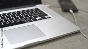 Hand connecting usb hard drive to laptop, modern personal computer technology