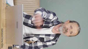 Vertical video of The old man who got angry at what he saw on the laptop.