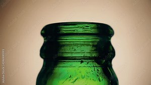 Man with a corkscrew opens a bottle of wine on a black background