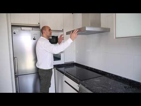 A very small, narrow modern kitchen with granite countertops