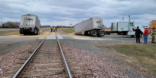 Train collides with semitruck, splitting trailer carrying grain in half