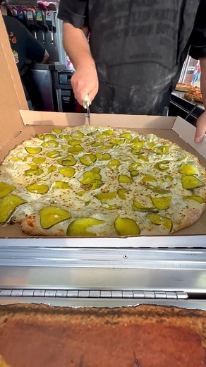 Pickle Pizza! 🤯🍕 Hand-tossed pizza tossed with homemade specialty dill sauce, fresh mozzarella, thick crunchy dill pickles, and finally topped with Ranch sauce! 🤯🍕 #pizza #pickles #picklepizza | Foody Fetish