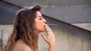 European french woman smocking. Lifestyle in France streets. Unhealthy smoke habits. Smoking cigarettes every day. Isolated european woman.