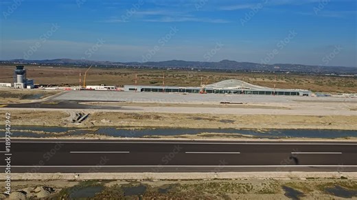 Aerial view of the new international airport under construction in Vlore Albania, a project known for repeated delays, showing unfinished runways, buildings, and large scale infrastructure development