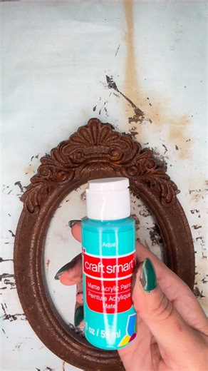 I made this Steampunk frame using a Dollar Tree frame and tart-tin mould. I gave it a patina-rust effect using paint and cinnamon powder. 🤎🩵🤎 #diy #crafts #patina #rustic #steampunkstyle | Handmade by Rosalinda