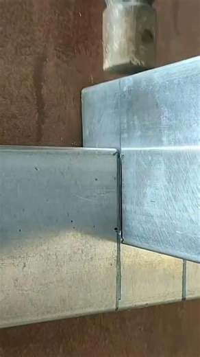 Installing metal along the wall edge carefully to ensure a strong, neat, and durable finish.