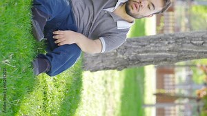 Vertical Video of Dwarf young man fainting outdoors. Dizziness.