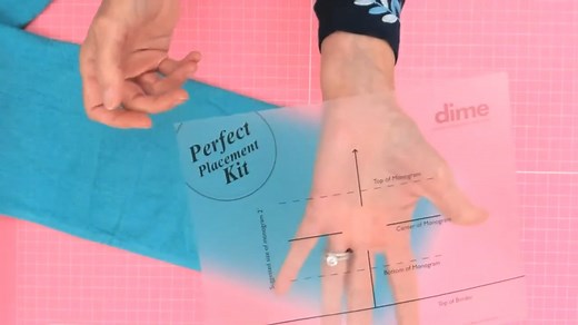 Working on multiples can be tricky, especially with the placement of your design. With the Perfect Placement Kit™, it’s easy to achieve perfect placement of designs on almost everything—napkins, towels, shirt cuffs, left chest, and more. Watch Eileen show how easy it is to use our Perfect Placement Kit on a towel. #embroideryplacement #machineembroidery | DIME by OESD