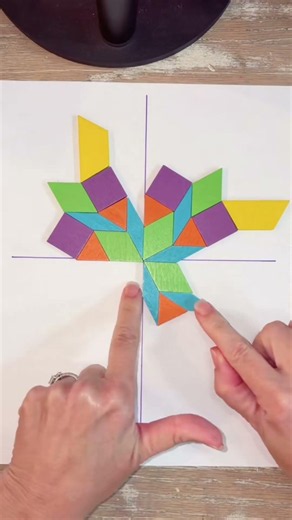 Use pattern blocks to build a pattern with 90 degree rotational symmetry