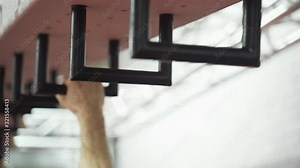 Man climbing the monkey bars. Close up