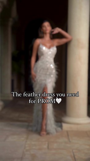 CC2358 is expertly crafted from the finest fabric, this stunning piece is sure to make you shine. Featuring thin straps with a v-neckline, this dress is guaranteed to flatter your figure. The boned beaded bodice provides a perfect foundation, while the feather adorned skirt adds an enchanting touch of glamour. The lace up corset back hugs your curves and the leg slit is the perfect finishing detail. Twirl on the dancefloor and make a glamorous statement. This fitted embellished feather gown is p