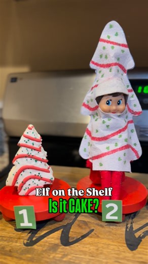 Jenni Christiansen on Instagram: "Is it CAKE? is one of my kids favorite shows so obviously the elves needed to recreate it Christmas style for them! Materials Needed: 🌲 @thereallittledebbie Christmas cakes 🌲 Elf Costume - made with 1 piece of felt, markers and hot glue 🌲 any other small fake trees you have around your house. If you want the link to the ornament I used comment CAKE and I’ll send it your way! #elfontheshelfideas #elfontheshelf #busymom #busymomlife"