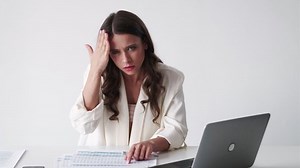. Blaming chief. Meme expression. Accusing woman beating head with hand pointing on working documents data sitting desk white background looped.