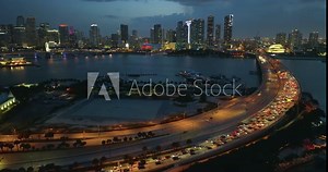 Traffic jam on Miami highway at night. USA transportation infrastructure. Aerial view of American freeway slowdown with stuck cars in Florida.