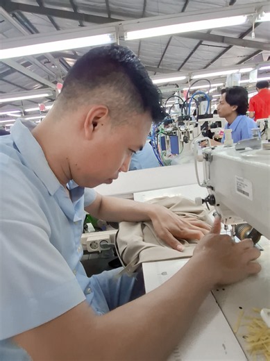 Garment factory sewing operator at a sewing machine