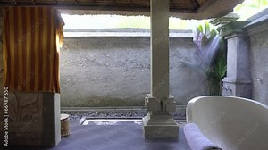 hot steamy shower in hotel bathroom In Bali Indonesia. the outdoor shower and stone tile make it a great spot for vacation