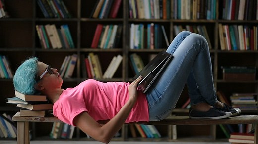 Girl laying down with her laptop - Free Stock Video