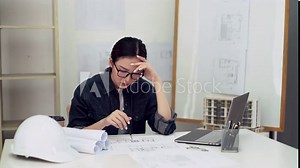 4k video of Frustrated woman engineer after work hard and busy work out boring day concentrated architect having some problem with measurements look like headache and so tried.