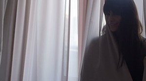 clip-24471566-female-peeking-out-behind-curtains