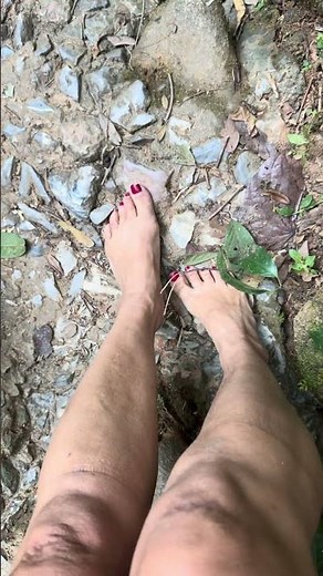 Careful barefoot walk down a steep jungle path