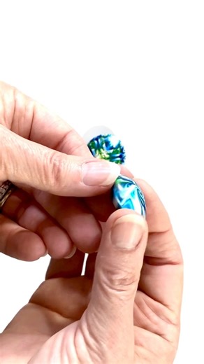 I used some of the leftover scraps from my Das Smart Polymer Clay cane to make a couple of beads. I added the holes easily, with very little distortion, and leaving few fingerprints. Baked, the beads had a nice shine, which was even better with sanding and polishing.So, with only short time to play and experiment here are my personal findings. I found it a firm clay that blends and canes well, and it is non sticky. Reducing a large cane was hard, if you have problems with manual dexterity or art