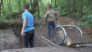 children digging shovels trench in the ground