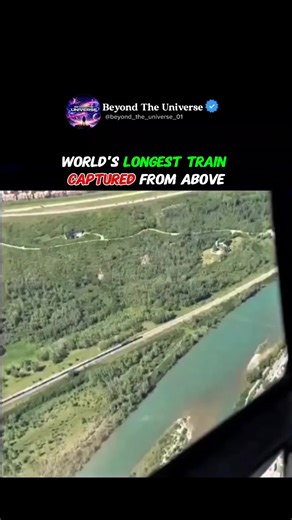 This video shows an aerial view of what could be one of the longest trains in the world, captured from a helicopter. The train appears to stretch endlessly across the landscape, consisting of hundreds of connected cars moving in unison. Trains like these are often used in mining and freight operations, especially in countries like Australia, where the BHP iron ore train can exceed 7 kilometers in length. Helicopter footage offers a rare perspective, highlighting the scale, engineering, and coord