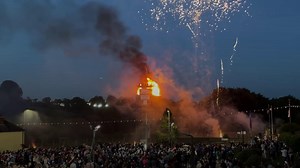 A loyalist bonfire in Northern Ireland, controversially topped with an effigy of migrants in a boat, has been lit as the PSNI launch a hate crime investigation. | Belfast Live