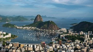 Rio de Janeiro, Brazil, sunset timelapse view of Rio cityscape including natural landmark Sugar Loaf Mountain and Guanabara Bay during summer.