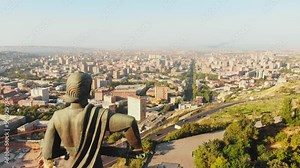 Yerevan, Armenia - 2nd september, 2021: The statue of Mother Armenia. Mother Armenia Monument aerial close circular view. In background street, buildings Victory park In Yerevan