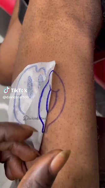 Exploring the Art of Smiling Tattoos by Davicotattoo