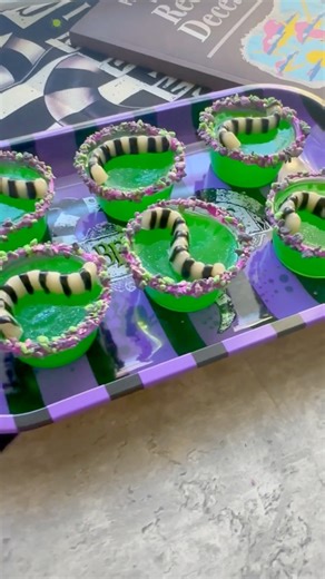 🪲 Beetlejuice Jello Shots Recipe! Follow the directions of whichever jello mix you’re using. Im using green apple gelatin sonic brand from Walmart. I use a 1 to 1 ratio. 1 cup boiling water and 1 cup alcohol (allow jello to cool 10 mins before adding alcohol). If you don’t want the shots too strong, use 1 1/2 cup boiling water and 1/2 cup alcohol. I use 2oz containers all the supplies will be linked here: https://tr.ee/BmjBoZ Optional: Edible glitter! Sandworm gummy recipe: 🐛Worm mold: Walmart