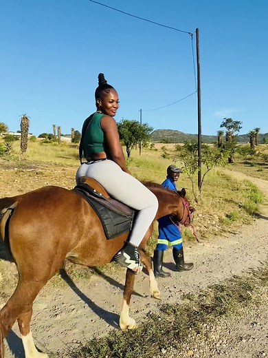 Woman Mounts Horse in Beautiful Outdoor Setting