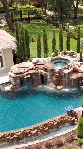 69K views · 1.7K reactions | What makes this an Insane Pool? The spa is built into the top of the grotto and sits 8.5 feet above the pool below. We used 168 tons of rock to build the grotto. The pool is 100 thousand gallons and 110 feet long, with a mild side for relaxation and a wild side with a treehouse and theme-park-sized water slide for those seeking a little excitement. #insanepools #lucaslagoons #pool #poolparty #poolbuilders #backyard #insane | Lucas Lagoons Design | Facebook
