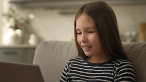 Little girl laptop computer grimacing emotions expression child kid playing game website technology online face excited female electronic problem wifi internet using gadget pastime difficulty distress