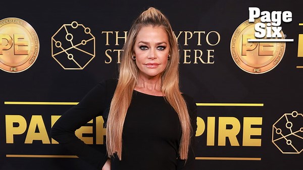 Denise Richards shows off some leg in a black gown at 'Paper Empire' Cannes event