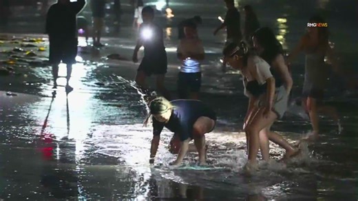 Grunion run draws crowds to Southern California beaches overnight; raccoon joins in